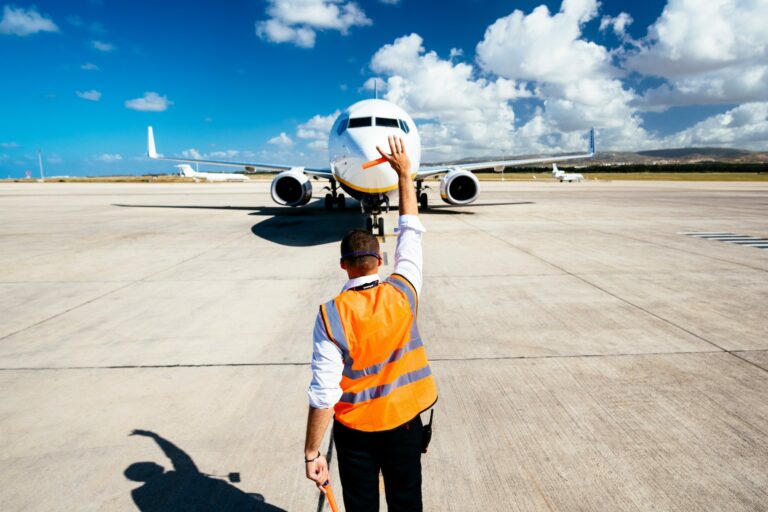 Ramp worker signaling to a plane