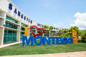 The outside of the Sangster International Airport, with a large "I (heart) Montego Bay" sign outside the entrance.