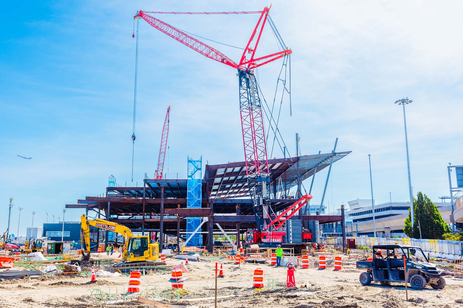 A large crane sits on a construction site for a new airport.