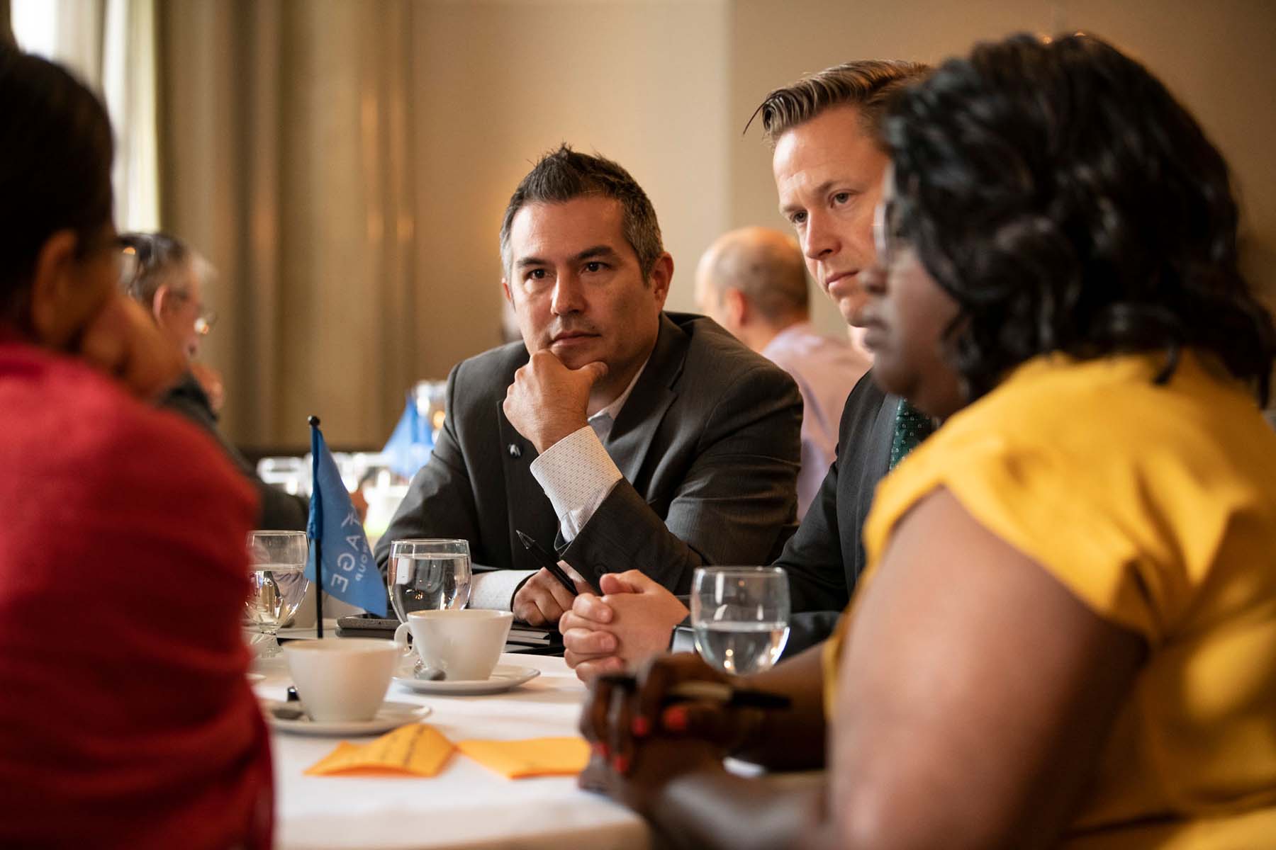 A group of people at a table discuss a project during a Vantage people workshop.